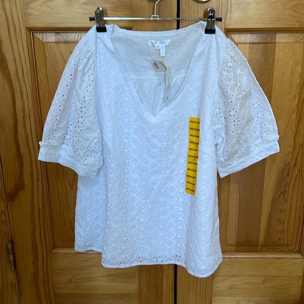 New with tags eyelet top, V neck with puff sleeves.
